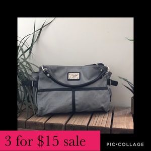 Grey bag with black accents. Faux leather material